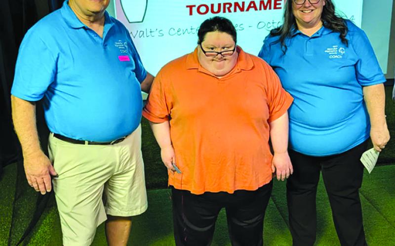 Bowling coaches Jude, left, and Toni Zilliox stand with Elijah Combs, center, who placed fifth last week in the Northern Kentucky Special Olympics Regional Bowling Tournament. Photo courtesy of Judy Combs.