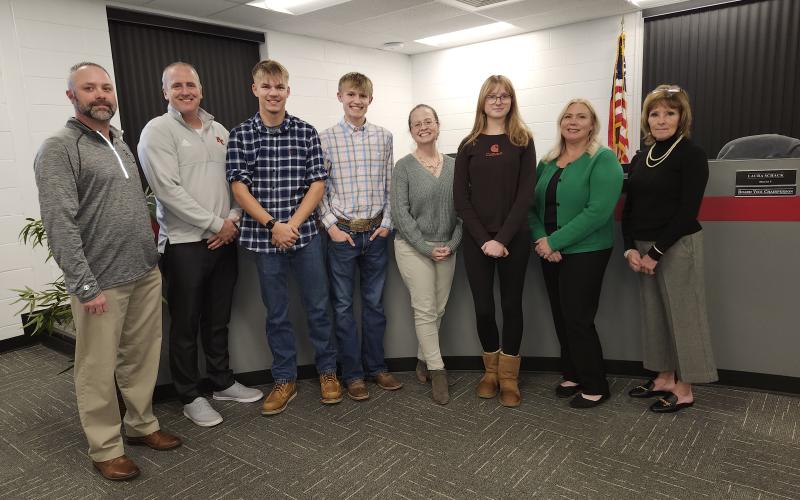 The Pendleton County Board of Education last week recognized cross country team members who qualified this year for state competition. From left are board members Derek Brown and Kevin Barnard, Pendleton County High School team members Sam Hodge and Klaber Wolfe, board member Laura Schack, Sharp Middle School team member Taylor Flannigan, and board members Amber Beebe and Cheryl Griffin. Photo by Burton Cole.