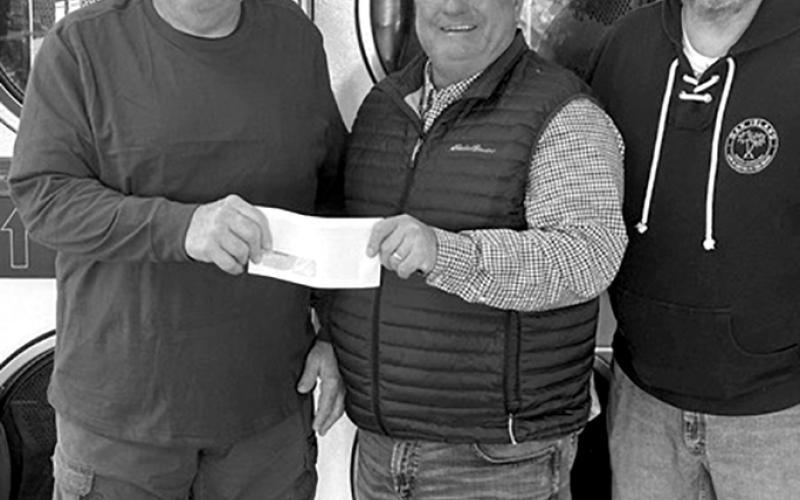 Early Bird Laundry, 211 Park St., Falmouth, said it will put the grant to use by upgrading equipment. “We purchase some newer washers and dryers each year,” owners Don and Karen Miller stated. The family operated laundry has been in business for 13 years, and “the next-closest laundromat is 20-plus miles away,” they stated. Here, Don Miller, left, accepts a check from Chamber President Gary Hicks and Chamber member Randy Wells.