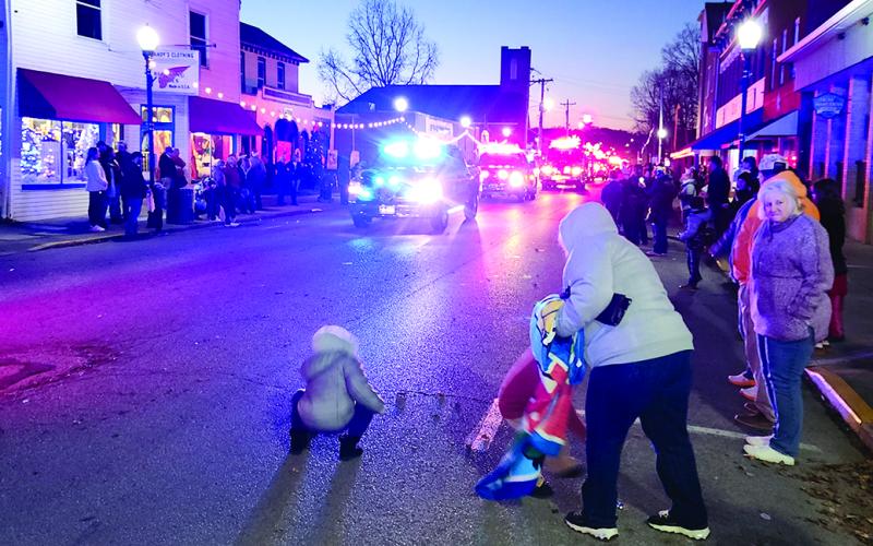 Youngsters scrambled to pick up candy before the next parade entries pass by tossing more sweet treats to the crowd. The next Pendleton County Christmas parade is 6 p.m. Saturday in downtown Butler.