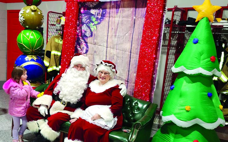 After the parade, Santa and Mrs. Claus met with youngsters at the Falmouth Fire Department on Main Street.