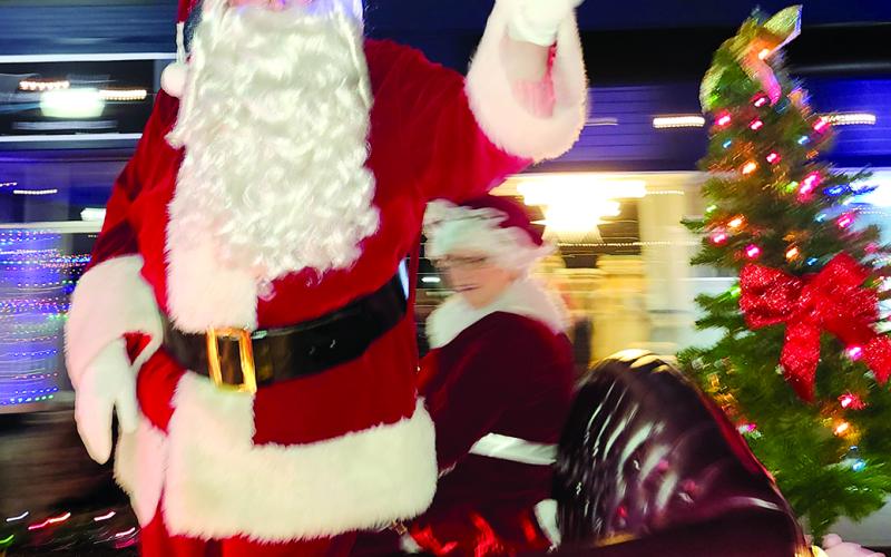 Special guest Santa Claus waves to the crowds lining Shelby Street in downtown Falmouth Saturday during the annual Christmas parade. Photo by Burton Cole.