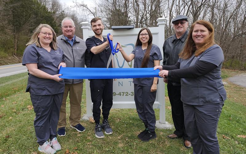 Cutting the ribbon to officially open Riverside Dental with its new dentist are, from left, Kristen Holbrook, dental assistant; Gary Hicks, president, Pendleton County Chamber of Commerce; Dr. Christian Zint, dentist; Maggie Thomas, front office staff and Zint’s wife; Neil Belcher, Chamber vice president; and Tammy Wessel, front office manager. Zint opened the office Dec. 2, and succeeds retired dentist Dr. Monte McElfresh. Photo by Burton Cole.