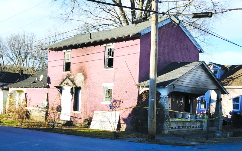 The historic brick building at Second and Maple streets in Falmouth received heavy damages in a Jan. 27 fire was the city's first jail in the early 1800s. It was boarded up over the weekend. Harold Macallister, who was buying the house from his brother Gary, who lived there, said he didn’t know if the building could be saved. Photo by Burton Cole.