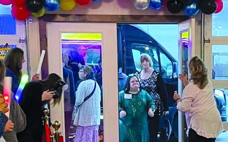 Guest Katie Peluso arrives at the venue, escorted by buddy Regina Pribble. Photos courtesy of Abram Crozier