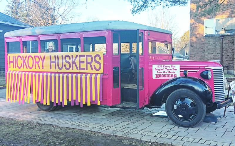 Outside of the entrance to the Hoosier Gym, a 1939 Chevrolet bus used in the 1986 basketball movie Hoosiers which includes a cutout photo of the film's star, Gene Hackman. Photos by: Sam McClanahan, Layne Nelson, and Justin Reckner.