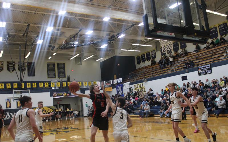 Senior Aden Merrill goes above his defender for two of his team-high 19 points.  Photo by Sam McClanahan