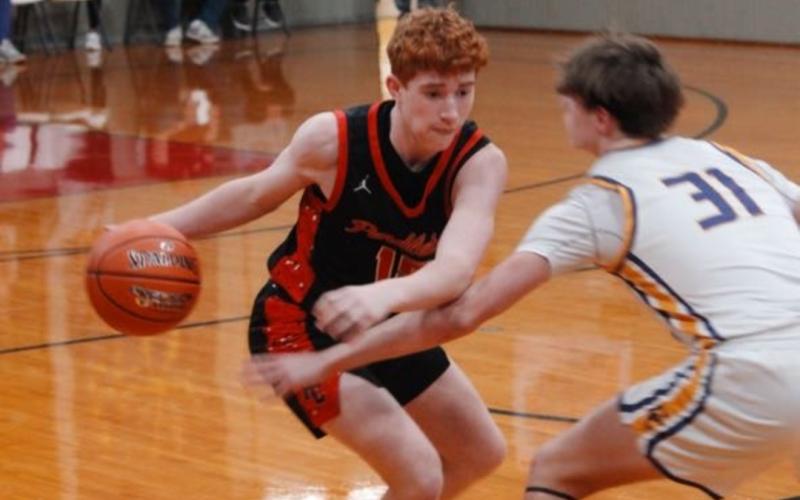 Sophomore Grayson Nelson looks to drive by his defender during the second half. Photos by: Sam McClanahan, Layne Nelson, and Justin Reckner.
