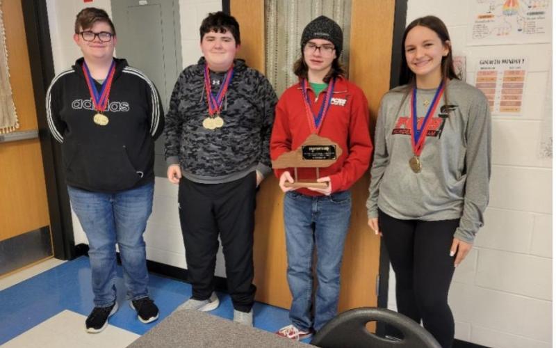 The Pendleton County High School Quick Recall team placed second at the District Governor's Cup. From left are team members Gavin Iles, Chase Stayton, team captain Autumn Webster holding the trophy and Rylan Anderson.