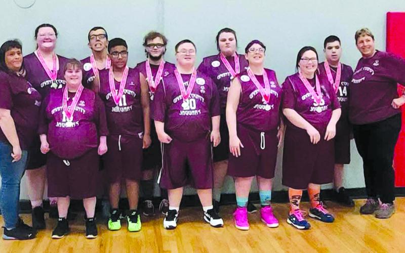 Sam Bryant stands front and center as his team, the Grant County Jaguars, display their silver medals after finishing second in their division in the state Special Olympic basketball tournament March 9 in Louisville. Team members are, back row from left, Mary Robinson, Dylan Williamson, Justice Schuster, Gabby Robinson and Jacob Goerke, and in the front row, coach Angela Robinson, Grace Lambert, Toby Hall, Bryant, Amanda Bass, Tracy Iles and coach Bevery Bass. Photos courtesy of Jodi Workman.