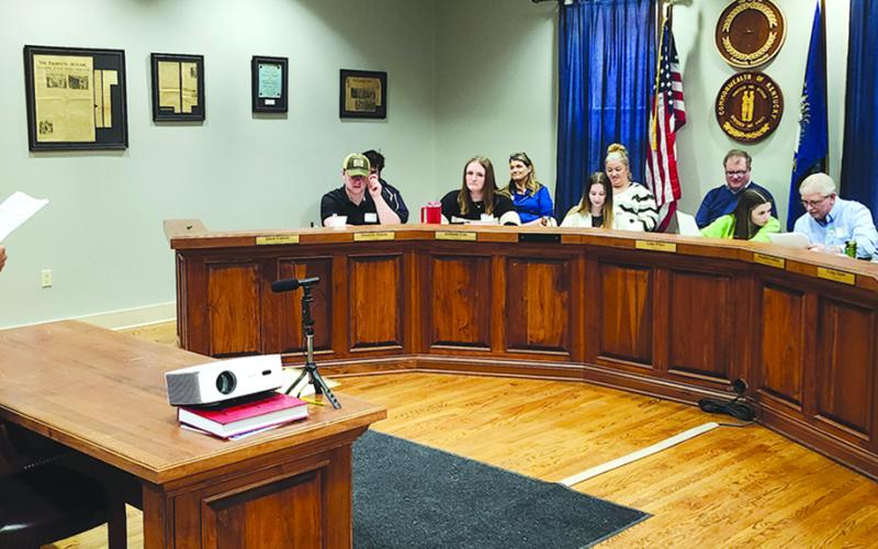 Pendleton County High School student Gavin Laney, left, portraying John “No More Tax Breaks” Benedict, states his case before “Kennett City Council” about why he opposes tax incentives to bring new business Plastics R Us into the city. The session Thursday in Falmouth City Council chambers was part of a Pendleton County Youth Leadership Economic Development Simulation that paired gifted students with mentors from Falmouth, the county and the state to develop more of an understanding of the process involved