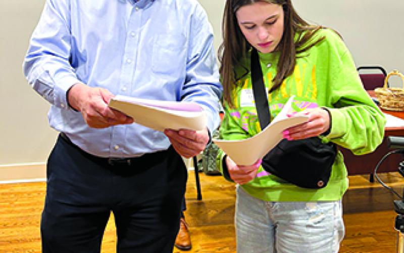 Cassie Callahan, right, who took on the role of the Mayor of Kennett City, consults with Pendleton County Judge Executive David Fields, her mentor in the economic development simulation. Photo by Tami Vater.