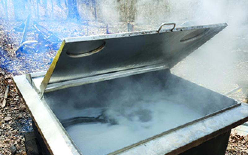 This is the dairy farm milk tank that Jeff Pettit's father used to boil sap. Jeff demonstrated that method as well as his evaporator during Sugar Day on Saturday at the farm in Butler. Photos by Burton Cole.