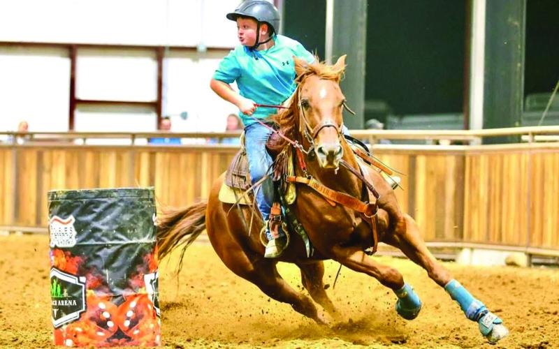 Harland Thomas, 10, of Butler, races the barrel course on Cruizin, the fastest horse he’s ever owned. He will ride the gelding in the NBHA Youth World Championship competition this July.