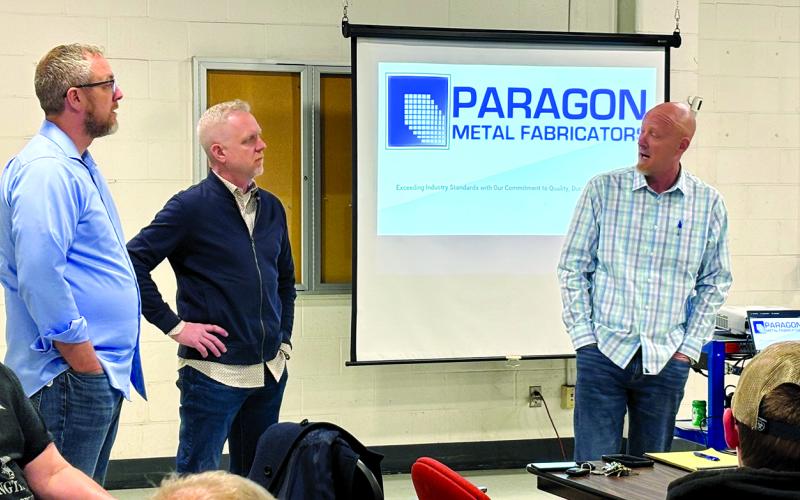 Brothers Matthew, left, Jason and Bryan Muehlenkamp, owners of Paragon Metal Fabricators in Erlanger, meet Friday morning with employees of the closed Hammer Strength factory in Falmouth to discuss expanding Paragon into the Hammer Strength building and the job opportunities the move will create. Photo by Tami Vater.