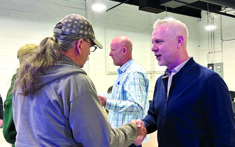 Jason Muehlenkamp, right, and his brothers greet workers who lost their jobs when Hammer Strength shut down its Falmouth operations. Photo by Tami Vater.