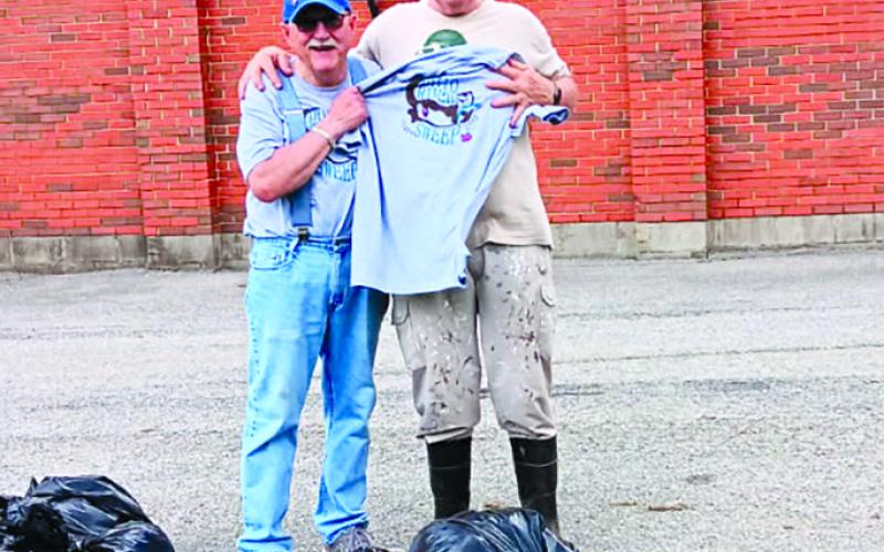 Mac McElfresh, left, and Ron Mouser, president of Butler Lions, display a few of the bags of trash picked up from roadways on April 19. Seven volunteers collected 23 bags of trash and debris. Photo courtesy of Butler Lions.