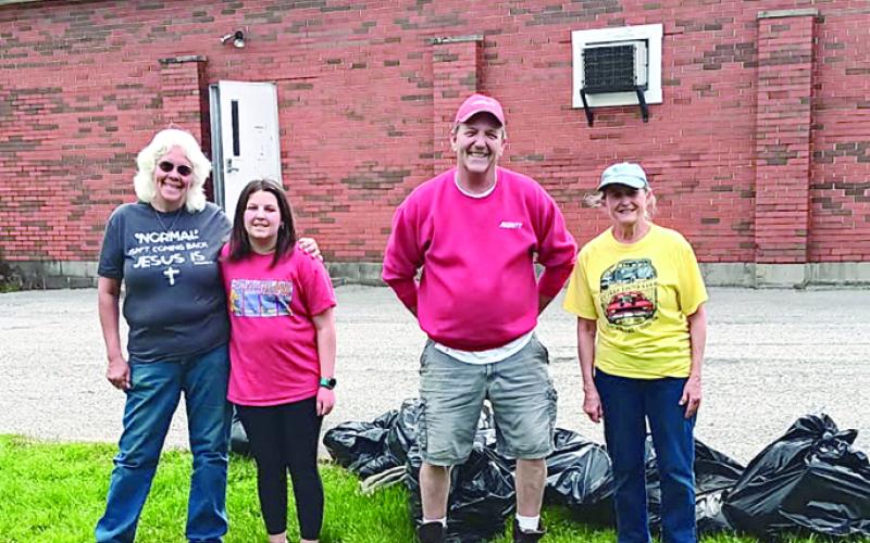 Gail Goetz, left, Lilly Hamlin, Jeff Bush and JoEllen Mitchell pose with more of the bags of trash. Not pictured is Bill Mitchell, who was busy picking up more debris. Photo courtesy of Butler Lions.