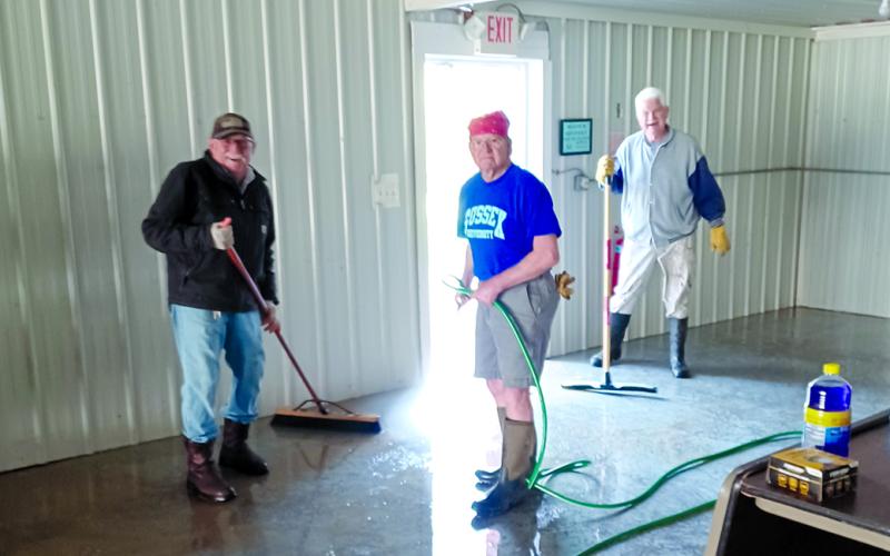 On April 22, members of Butler Lions clean the Butler Community Center, which was left with a thick covering of mud after the flooding of April 4 to 6. From left are Mac McElfresh, Bill Mitchell and Ron Mouser. Not pictured is Gail Goetz, who took the photo.
