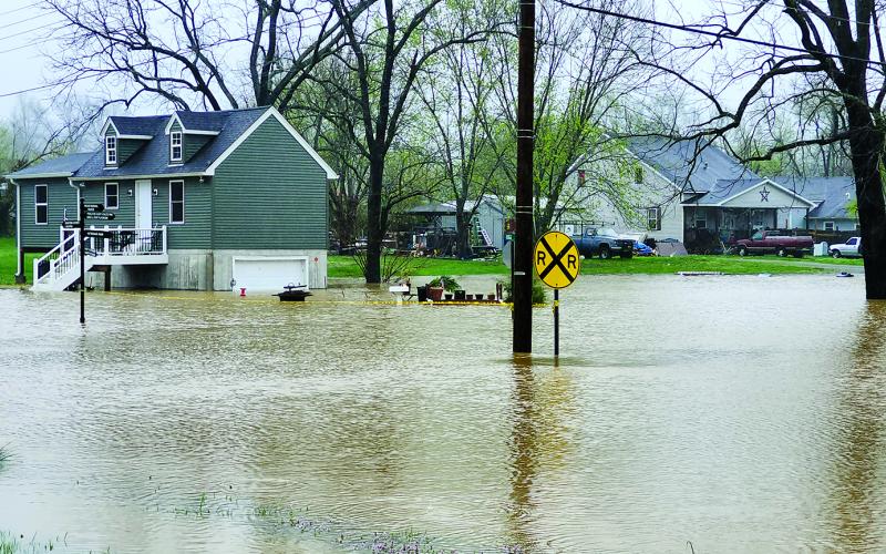 Flood waters overflow Rigg Street in Falmouth. Photo by Burton Cole