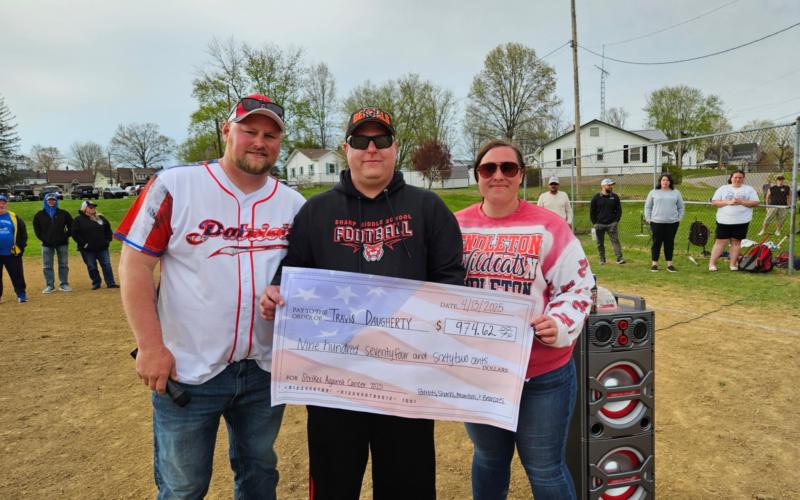 Travis Daugherty, center, shown with brother and Patriot baseball director Marty Daugherty, and friend Megan Smith, right. Monies raised from the tournament were given to support the Daugherty family.