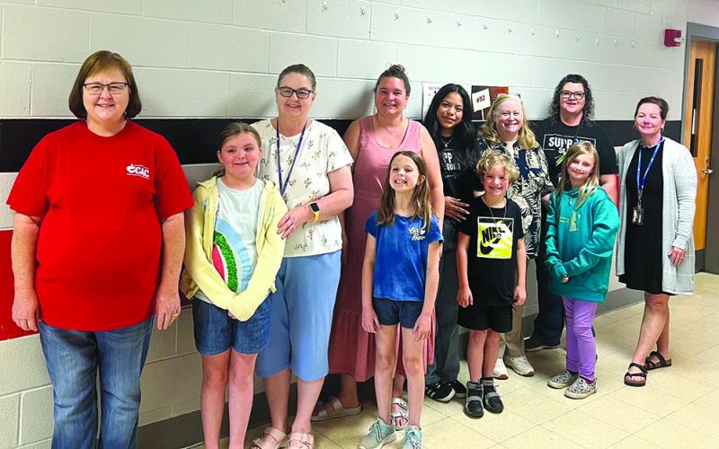 One to One Reading mentors at Southern Elementary School include, from left, Coach Jennifer Leising, Hayden, Reagan, teacher Jennifer McAfee, teacher Megan Helton, teacher Annabella Parker, Coach Bonnie Logan, Judah, Harley, teacher Lynn Murphy and organizer/media specialist Tina Record. Photos courtesy of Tina Record.