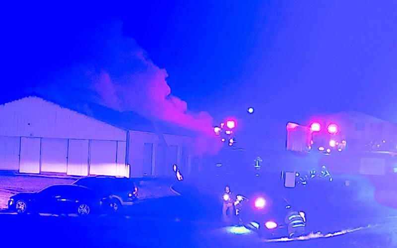 Smoke continues to pour from the building after the fire is knocked down. Photo by Burton Cole.