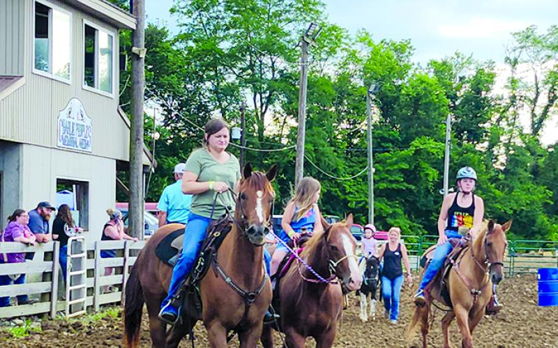 Riders warm up their horses Thursday night before barrel races kicked off the horse show. Photo by Burton Cole.