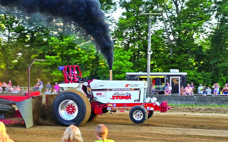 Front wheels leave the ground as a tractor charges forward Friday in the Battle of the Bluegrass Truck and Tractor Pull. Photo by Jenny Smith.