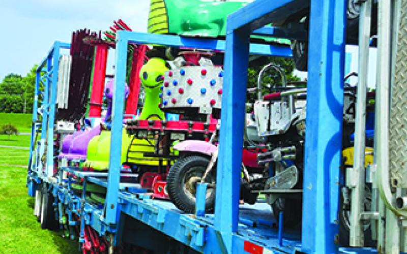 A trailer full of rides is parked and ready to be set up on the carnival portion of the fairgrounds.