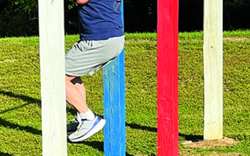 Kincaid Lake State Park Manager Dave Billings does pull-ups as part of the Murph Challenge.