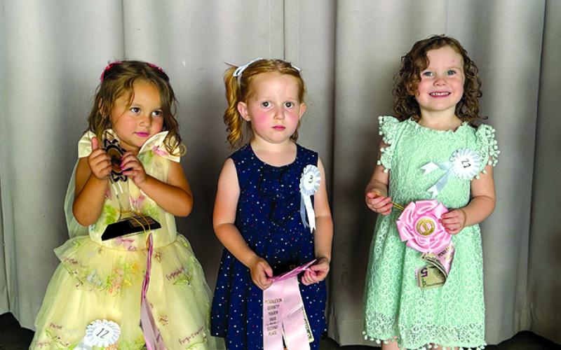 Taking the top prizes in the Tiny Miss Cutie Pie contest are Claira Browning, winner; Sophie Underwood, first runner-up; and Madelyn Buckner, second runner-up.
