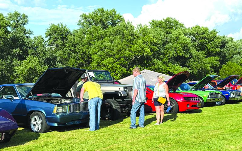 Cruise-In-goers inspect some of the classic cars on display Saturday in Butler.  Photo by Nila Harris.