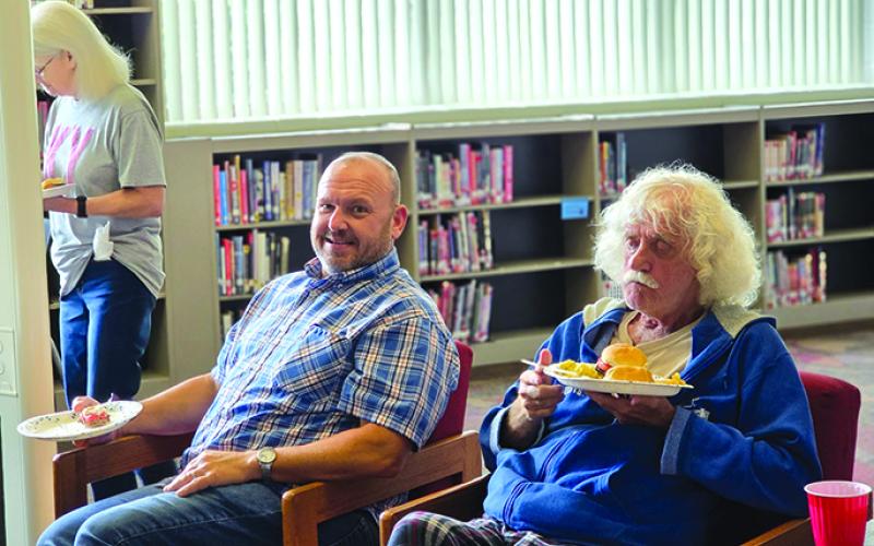 Pendleton County schools bus drivers Jimmy Gregg, right, and Bill Feltner, and bus monitor Louise Browning enjoy their lunch. Photo by Nila Harris.