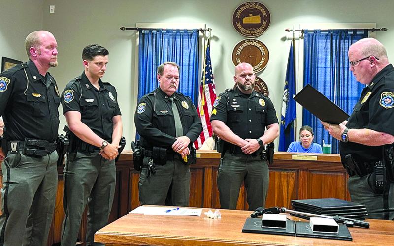 Falmouth City police who were awarded commendation medals and citations from police Chief Marty Hart, right, during a City Council meeting last Thursday for their actions during a May 17 rolling shootout between the passengers in two vehicles were, from left,  Assistant Chief Nick Timon, Officer Matthew Campbell, Sgt. Ken Hall and Sgt. Brody Schmeing, Not pictured are officers Shy Thompson and Kyle Florer. Photo by Jim Thaxton.