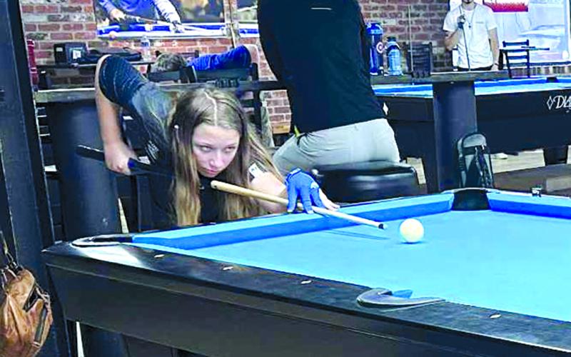 Jeanna Gregg, 12, of Falmouth, lines up a shot at the 2025 Junior World All-Around pool tournament in Louisville. She was the youngest out of 40 contenders at the event. Photo courtesy of Gale Gregg.
