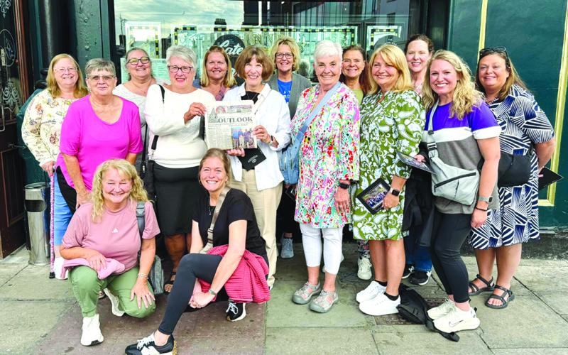Carrying the Falmouth Outlook to Ireland and Scotland were this group of travelers from Pendleton County. Kneeling in front are Shelly Peoples, left, and Diana Jones. Standing in front from left are Carol Caldwell, Lisa Arnold, Carole Bowin, Joy Bastin, Kim Myers, Randi Mullaney and Jamie Fields. In the back row are Bonnie Logan, Natalie Doyle Smith, Debbie Wright, Angela Horn, Kenna Knight and Paula Sevier. Missing from the photo is Lindie Huffman.