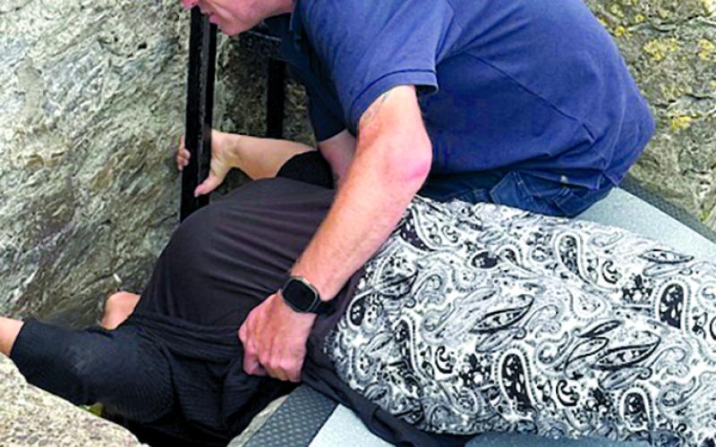 While a guide steadies her, Kenna Knight of Peach Grove kisses the famed Blarney Stone, which is 85 feet off the ground in Blarney Castle in Cork County, Ireland. Legend has it that whoever kisses the Blarney Stone will gain eloquence of speech.