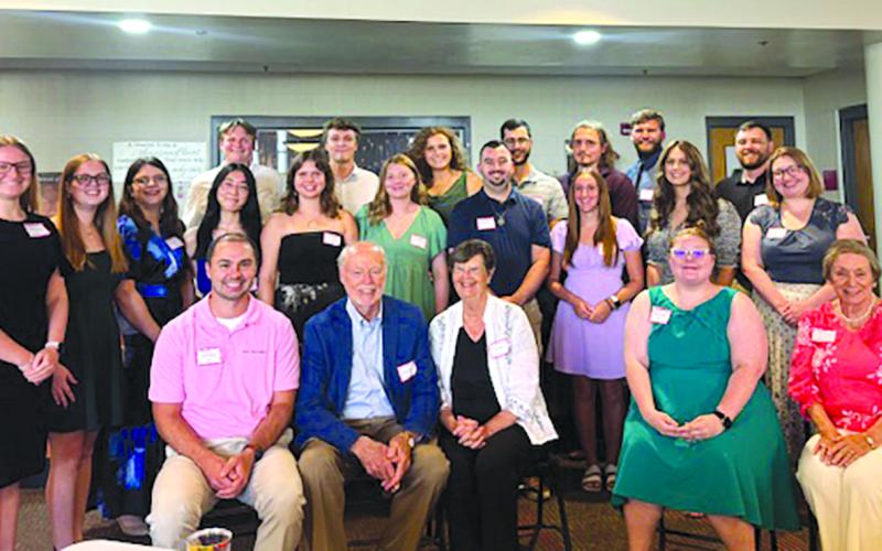 Sharp Scholarship recipients in attendance at the July 25 debut of the documentary “Cracking the Code: Phil Sharp and the Biotech Revolution” are, front row from left, Bryan Woods (2012), Dr. and Mrs. Sharp, Kitrina Justus (2018), Carol Klaber, Sharp Scholarship contact; second row, Shelby Eckart (2022), Emily Best (2025), Alexandria Black (2024), Annie Lin (2025), Allie Redden (2021), Grace Beebe (2017), Jared Wolfe (2016), Calliope Warren (2024), Savannah Schlueter Monroe (2012)  and Dr. Mariah Moore (201