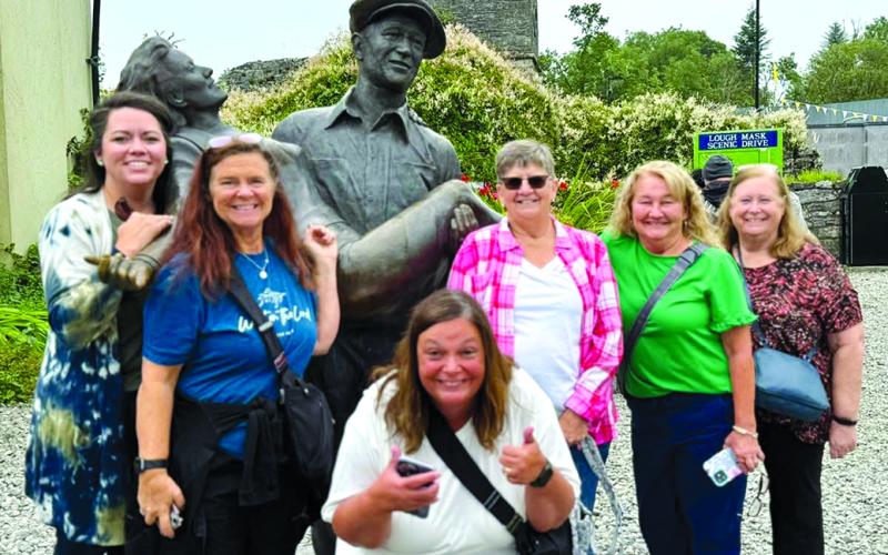 Posing with a statue of John Wayne and Maureen O’Hara in Cong village, County Mayo, are, from left, Lindie Huffman, Kenna Knight, Jamie Fields, Carol Caldwell, Shelly Peoples and Bonnie Logan. Wayne and O’Hara starred in the 1952 film “The Quiet Man,” which was shot primarily in Cong.