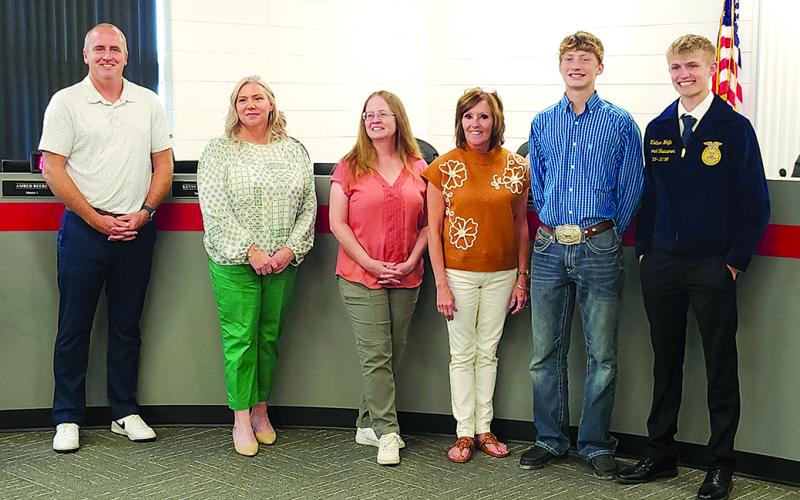 At its Sept. 15 meeting, the Pendleton County School Board honored its FFA students’ achievements at the Kentucky State Fair. From left are board members Kevin Barnard, Amber Beebe, Laura Schack and Cheri Griffin, and FFA members TJ Weinel and Klaber Wolfe. Photo by Burton Cole.