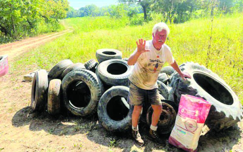 Johnson shows a pile of 50-plus tires that he Miller removed from the Licking River.