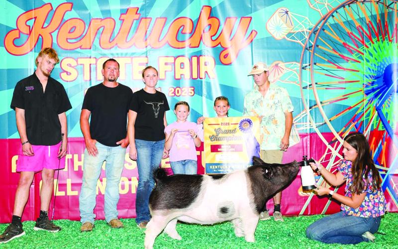 Ava Moore is all smiles as she displays her grand champion in the Novice Market, which got her into the Grand Drive on her first time at Kentucky State Fair.