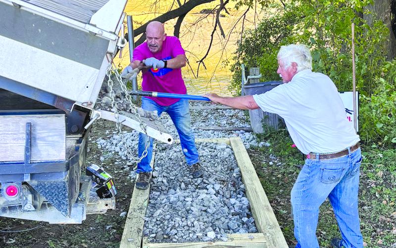 Joel Nahari and Barth Johnson fill the pathway forms with some of the 22 tons of No. 2 stone used on the project.