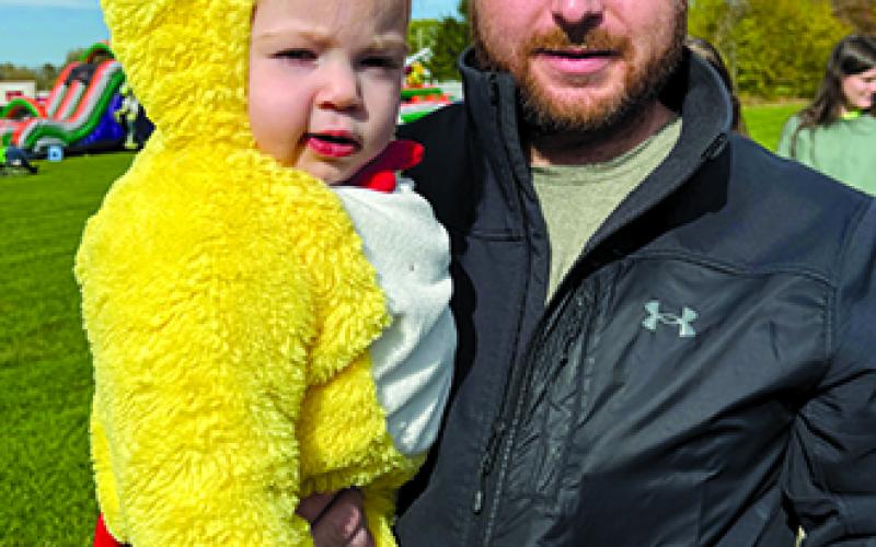 Reese Harris and daddy Mark sample the chocolate while trick-or-treating during Northern Elementary School PTO’s Trunk or Treat event.
