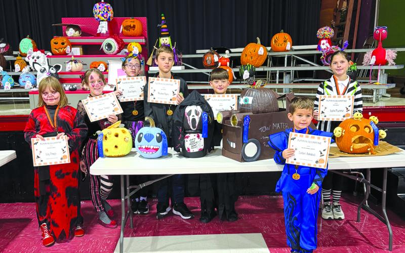 Lily and Maia Staggs, Principal’s Choice; Eve and Reuben Byers, Best Painted; Keegan Peoples, Scariest; Lydia Plummer, Best Carved; and, in front, Corbin Antrobus, Overall Favorite.