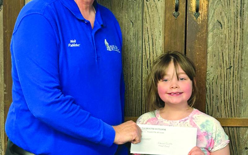 Belcher presents third place finisher Carson Courts, 8, of Falmouth, her $5 prize.