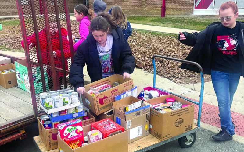 National Elementary Honor Society members at Southern Elementary load student-donated food for transport to the food pantry at the high school.