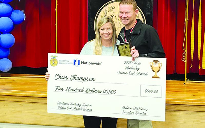 Pendleton County High School agriculture teachers Jaimie Mann, left, and Chris Thompson celebrate Thompson’s FFA Golden Owl Award for the Northern Kentucky Region. Photo by Burton Cole.