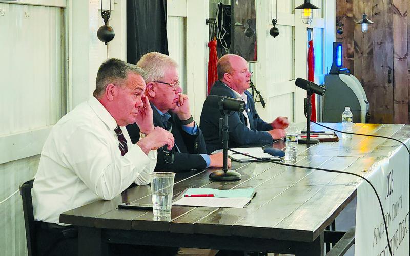 James Poynter, left, and Anthony Strong listen as Rick Mineer answers a question during a debate between candidates for Pendleton County Judge Executive March 25 at Pendleton Hills country club in Butler. The three, along with Sebastian Ernst, are vying to replace Pendleton County Judge Executive David Fields, who is retiring when his term expires at the end of the year.